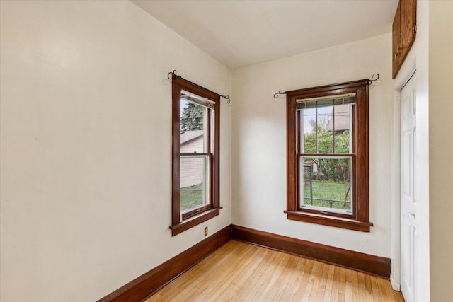 spare room with light hardwood / wood-style floors