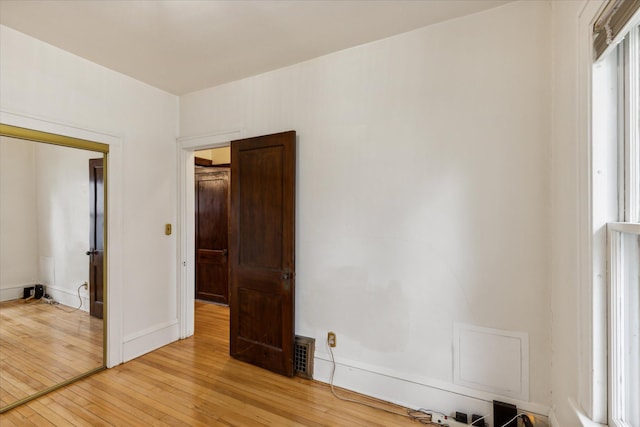 unfurnished bedroom with a closet and light hardwood / wood-style floors