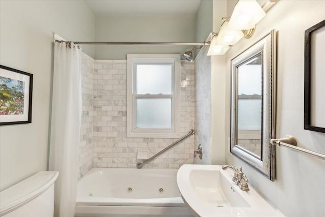 full bathroom with toilet, shower / tub combo with curtain, and sink