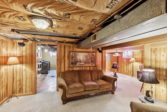 living room featuring carpet and wood walls