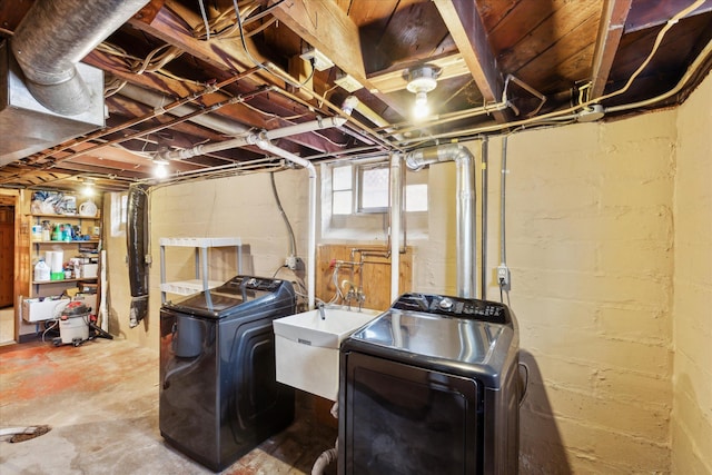 washroom with washer and dryer and sink