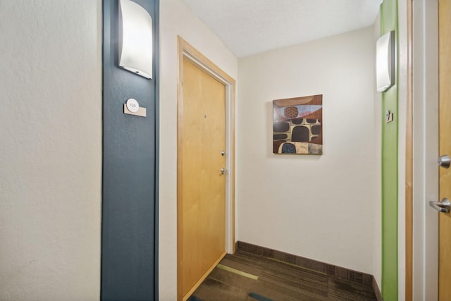 hallway featuring dark hardwood / wood-style flooring