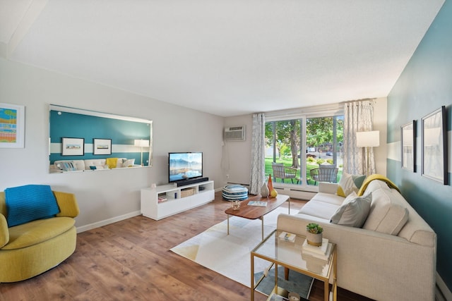 living room featuring light wood-type flooring, a baseboard radiator, and a wall mounted air conditioner