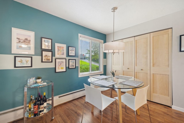 dining area featuring hardwood / wood-style flooring and a baseboard radiator