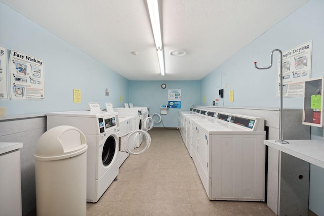 laundry area with light tile patterned flooring and washing machine and dryer