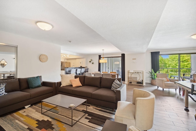 living room featuring a textured ceiling and light hardwood / wood-style floors