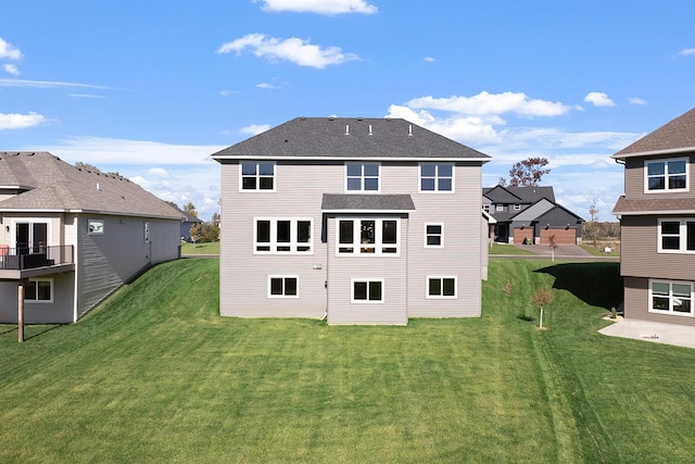 rear view of house featuring a yard