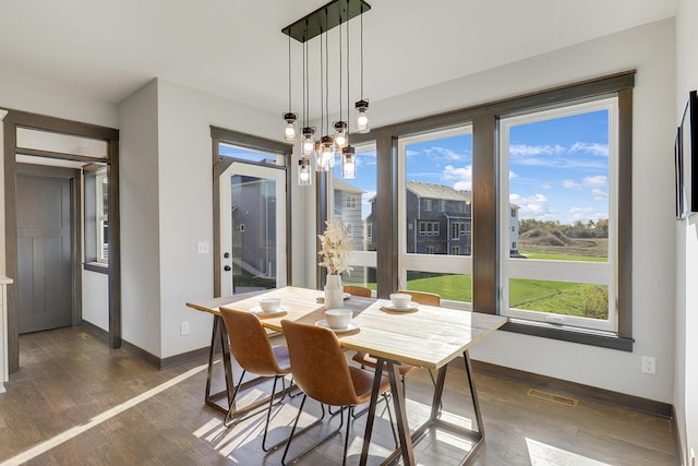 dining space with dark hardwood / wood-style floors and plenty of natural light