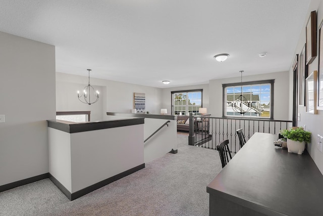 kitchen with light carpet, an inviting chandelier, and pendant lighting