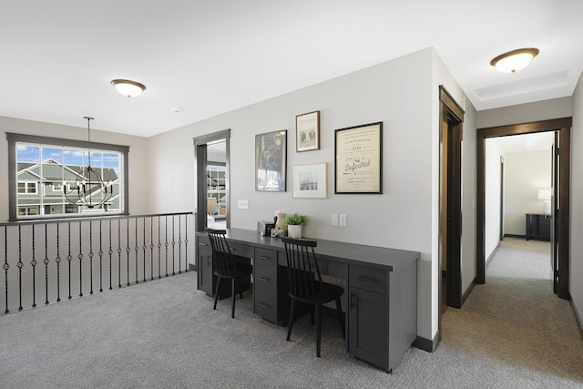 office space with a notable chandelier and light colored carpet