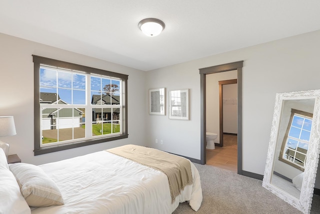 carpeted bedroom with connected bathroom