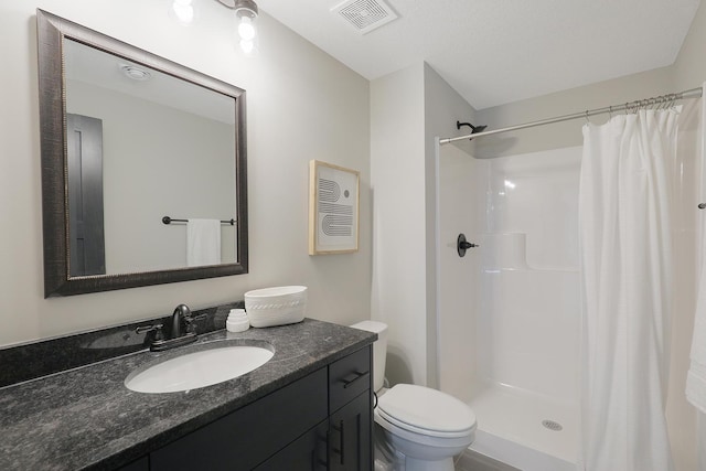 bathroom with vanity, toilet, and walk in shower