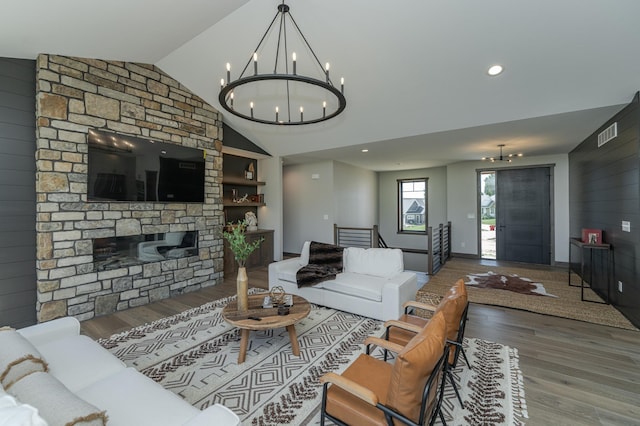 3185 Bella Terra Ln NE, Rochester, MN 55906 - living room featuring vaulted ceiling, a notable chandelier, visible vents, and wood finished floors