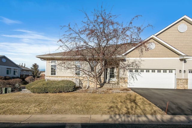 view of front of house with a front yard and a garage