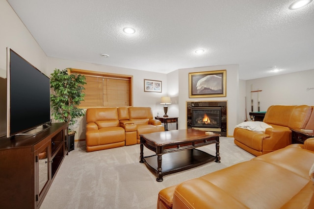 carpeted living room with a high end fireplace and a textured ceiling