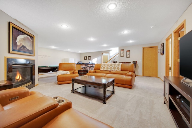 carpeted living room with a textured ceiling and billiards