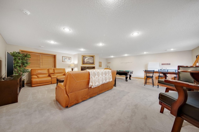 carpeted living room featuring a textured ceiling and billiards