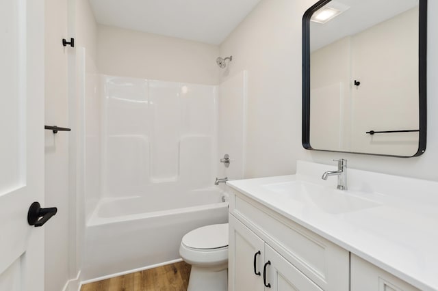 full bathroom with hardwood / wood-style floors, vanity,  shower combination, and toilet