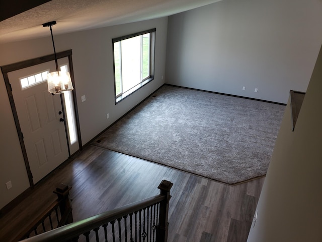 entrance foyer with a textured ceiling and dark hardwood / wood-style flooring