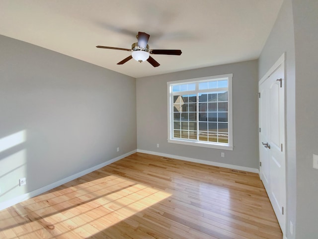 spare room with light hardwood / wood-style flooring and ceiling fan