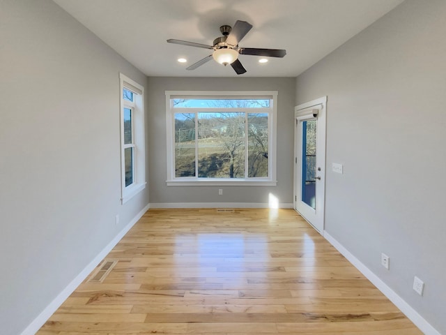 empty room featuring ceiling fan and light hardwood / wood-style floors