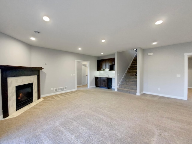 unfurnished living room featuring light colored carpet