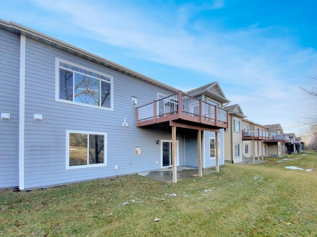 rear view of property featuring a lawn