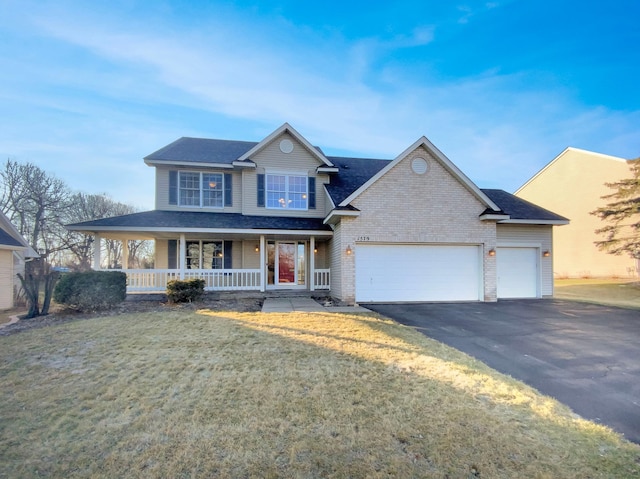 view of front facade with covered porch, a front lawn, and a garage