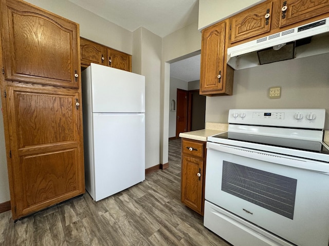 kitchen featuring dark hardwood / wood-style floors and white appliances