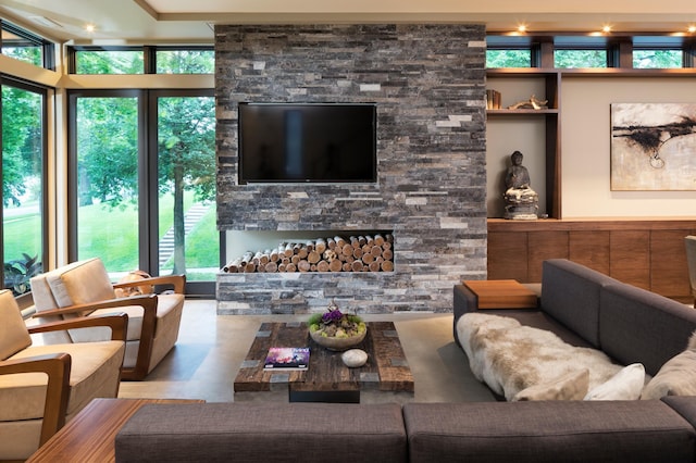 living room with a stone fireplace