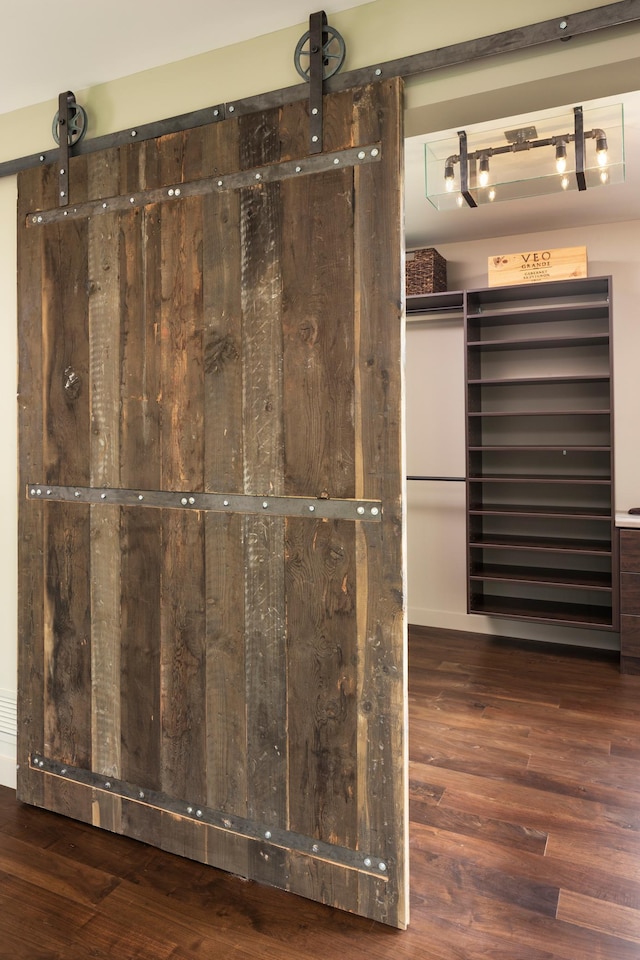 interior space featuring a barn door and wood finished floors