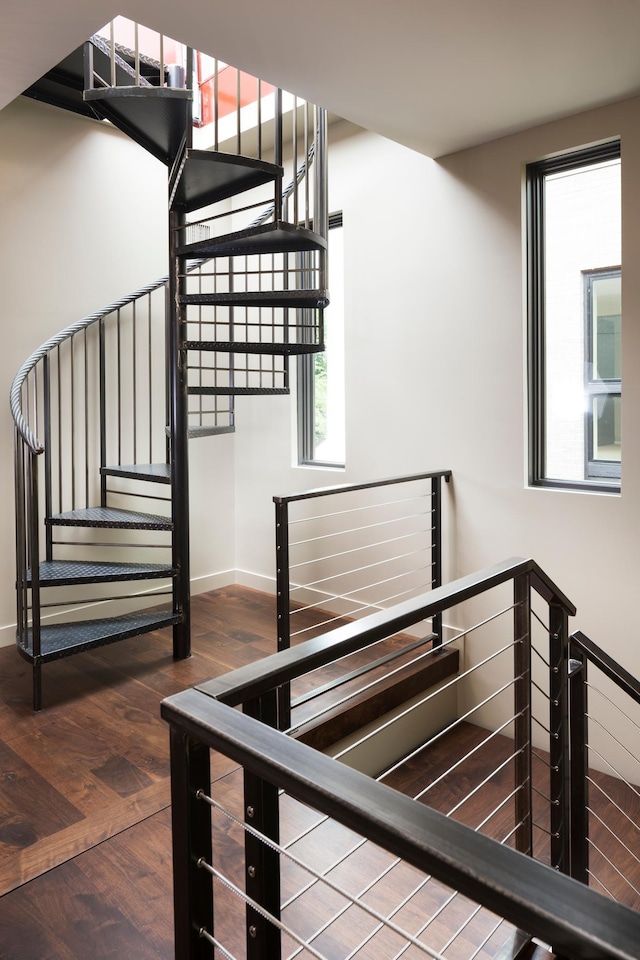 stairway featuring baseboards and wood finished floors