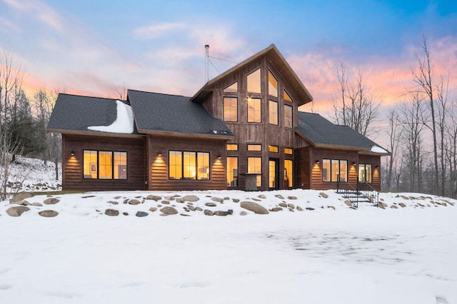 view of snow covered rear of property