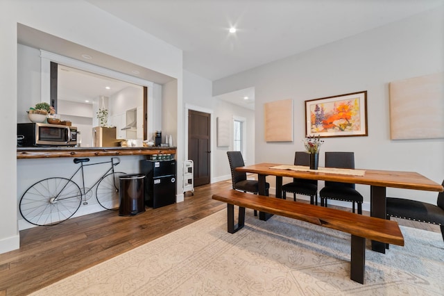 dining space with hardwood / wood-style flooring