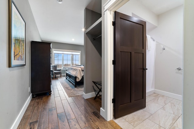 hallway with light hardwood / wood-style flooring