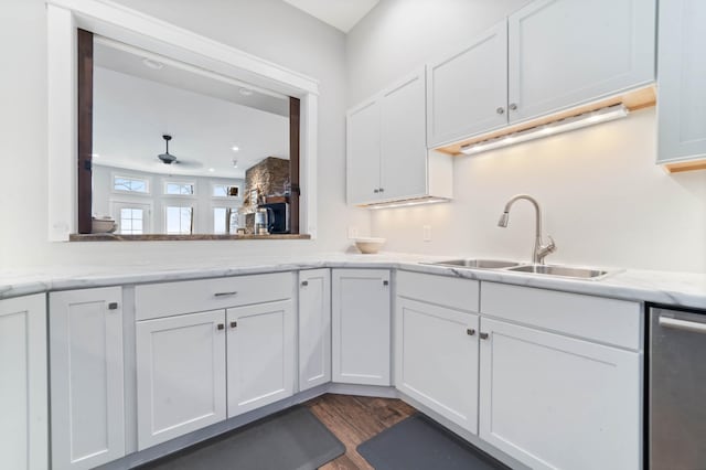 kitchen featuring sink, stainless steel dishwasher, and white cabinets