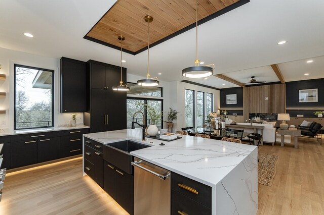 4163 Christopherson Ln SW, Rochester, MN 55902 - kitchen with dark cabinets, stainless steel dishwasher, a sink, modern cabinets, and open floor plan