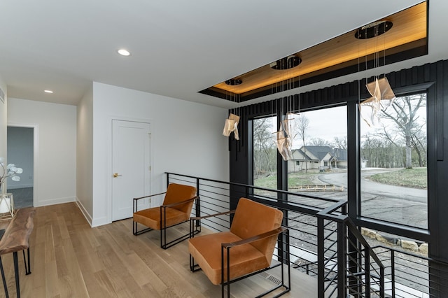4163 Christopherson Ln SW, Rochester, MN 55902 - sitting room featuring a raised ceiling, an upstairs landing, light wood-type flooring, recessed lighting, and baseboards