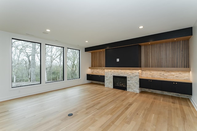 4163 Christopherson Ln SW, Rochester, MN 55902 - unfurnished living room with light wood-style floors, recessed lighting, baseboards, and a stone fireplace