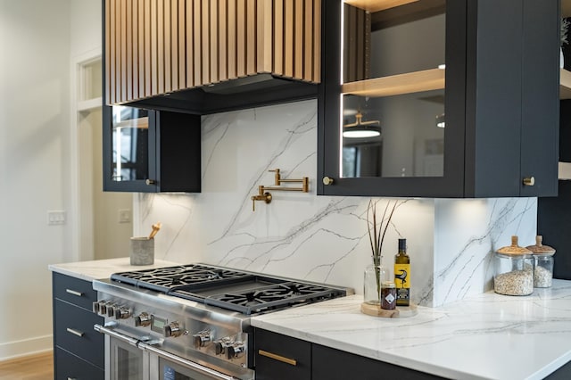 4163 Christopherson Ln SW, Rochester, MN 55902 - kitchen featuring range with two ovens, custom exhaust hood, dark cabinets, glass insert cabinets, and light stone countertops