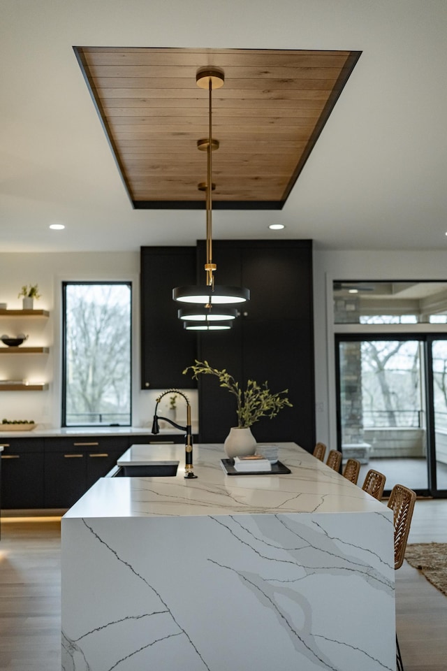 4163 Christopherson Ln SW, Rochester, MN 55902 - kitchen with a sink, dark cabinetry, healthy amount of natural light, light wood-style floors, and wood ceiling
