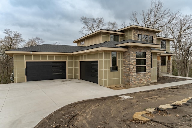 4163 Christopherson Ln SW, Rochester, MN 55902 - prairie-style house with stone siding, a garage, concrete driveway, and roof with shingles