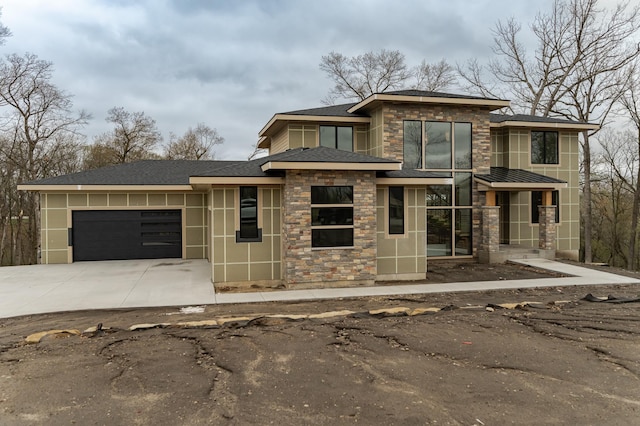 4163 Christopherson Ln SW, Rochester, MN 55902 - prairie-style house featuring concrete driveway, stone siding, a shingled roof, and an attached garage