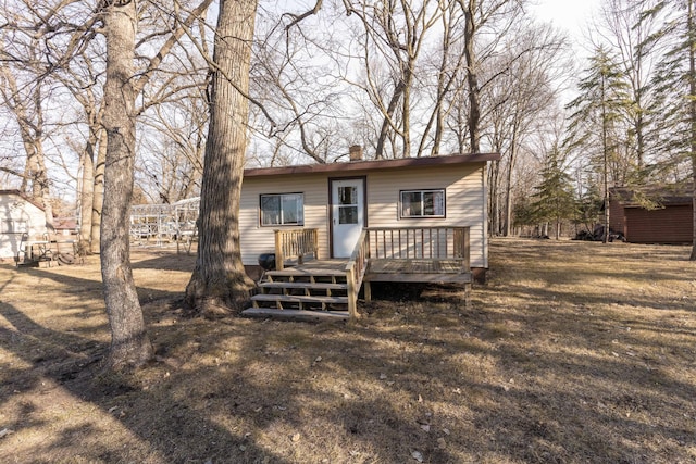 back of house with a wooden deck