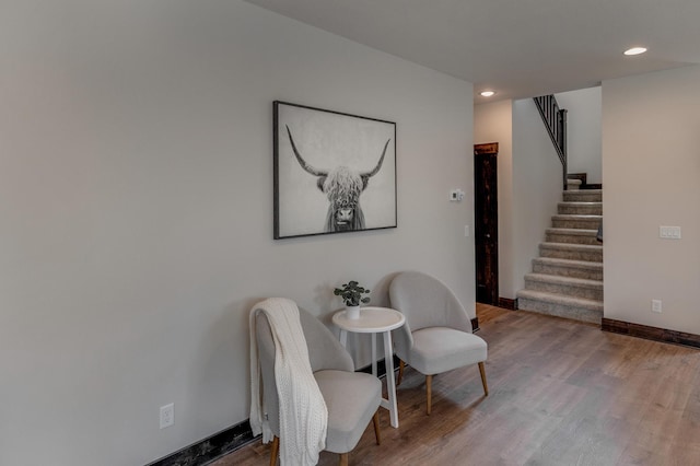 sitting room with hardwood / wood-style flooring