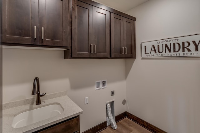 clothes washing area with electric dryer hookup, wood-type flooring, sink, cabinets, and washer hookup