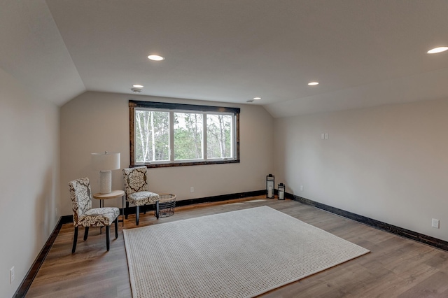 sitting room with light hardwood / wood-style floors and lofted ceiling