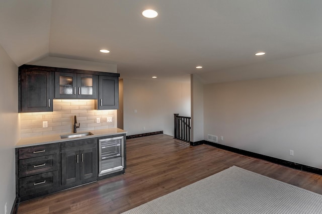 kitchen featuring backsplash, vaulted ceiling, dark hardwood / wood-style floors, and sink