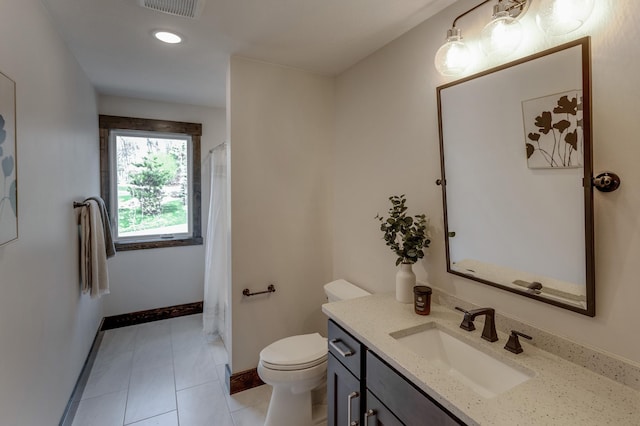 bathroom with toilet, tile flooring, and vanity