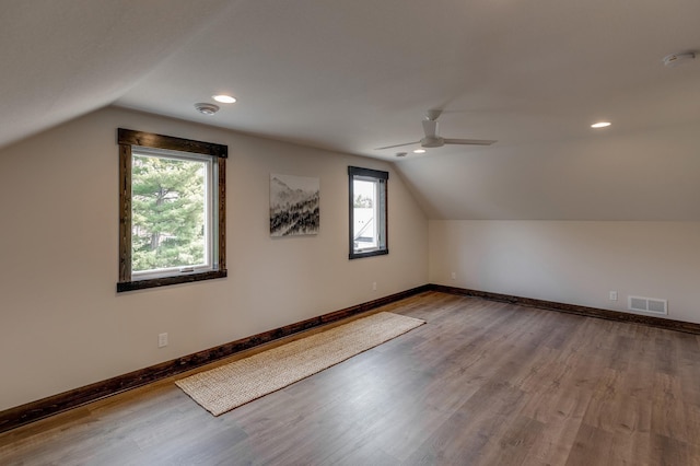 additional living space featuring ceiling fan, dark wood-type flooring, and lofted ceiling